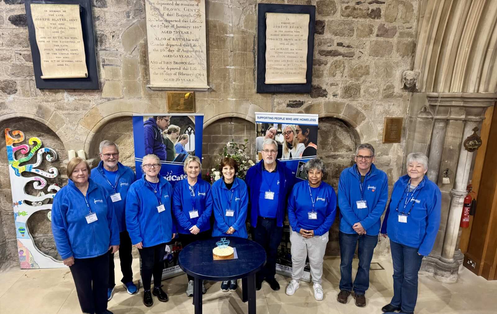 The SoundCafe volunteer team with a celebration cake